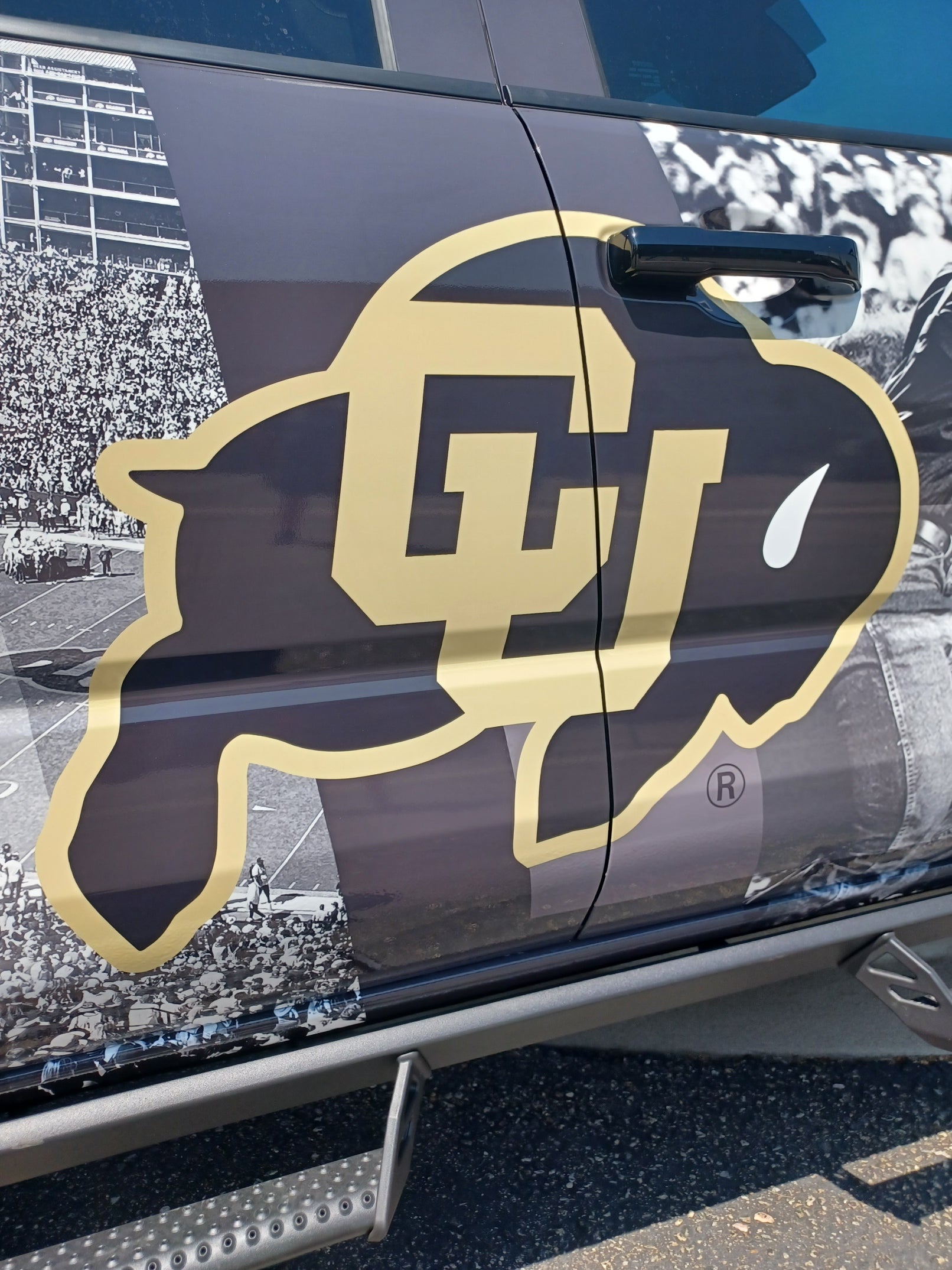 The passenger side of CU Boulder's full truck wrap, featuring the iconic CU Boulder buffalo logo.
