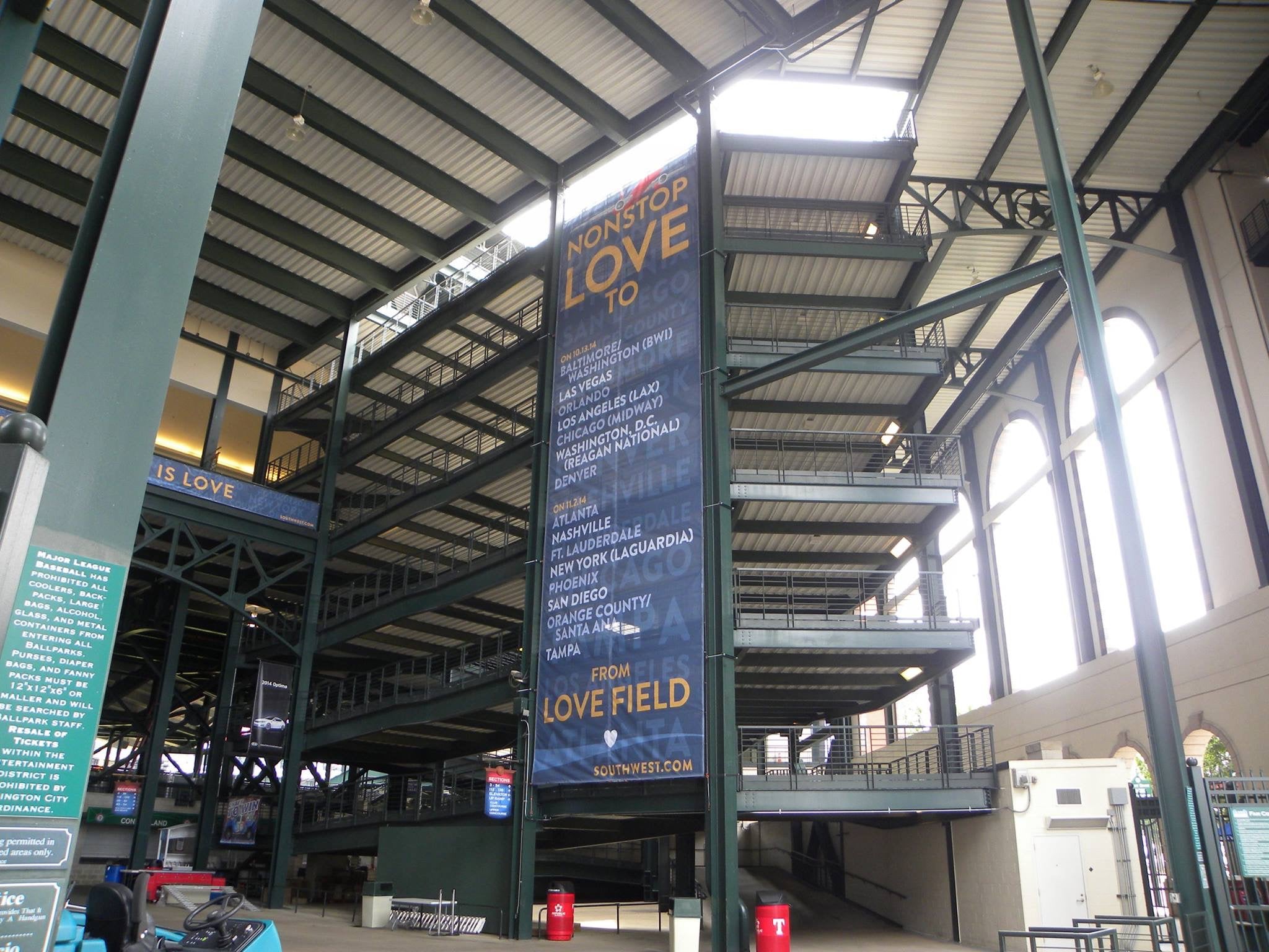 A tall vertical mesh banner installation at Globe Life Field in Arlington, Texas. The banner highlights Southwest Airlines destinations with the message "Nonstop Love to" and lists several cities.