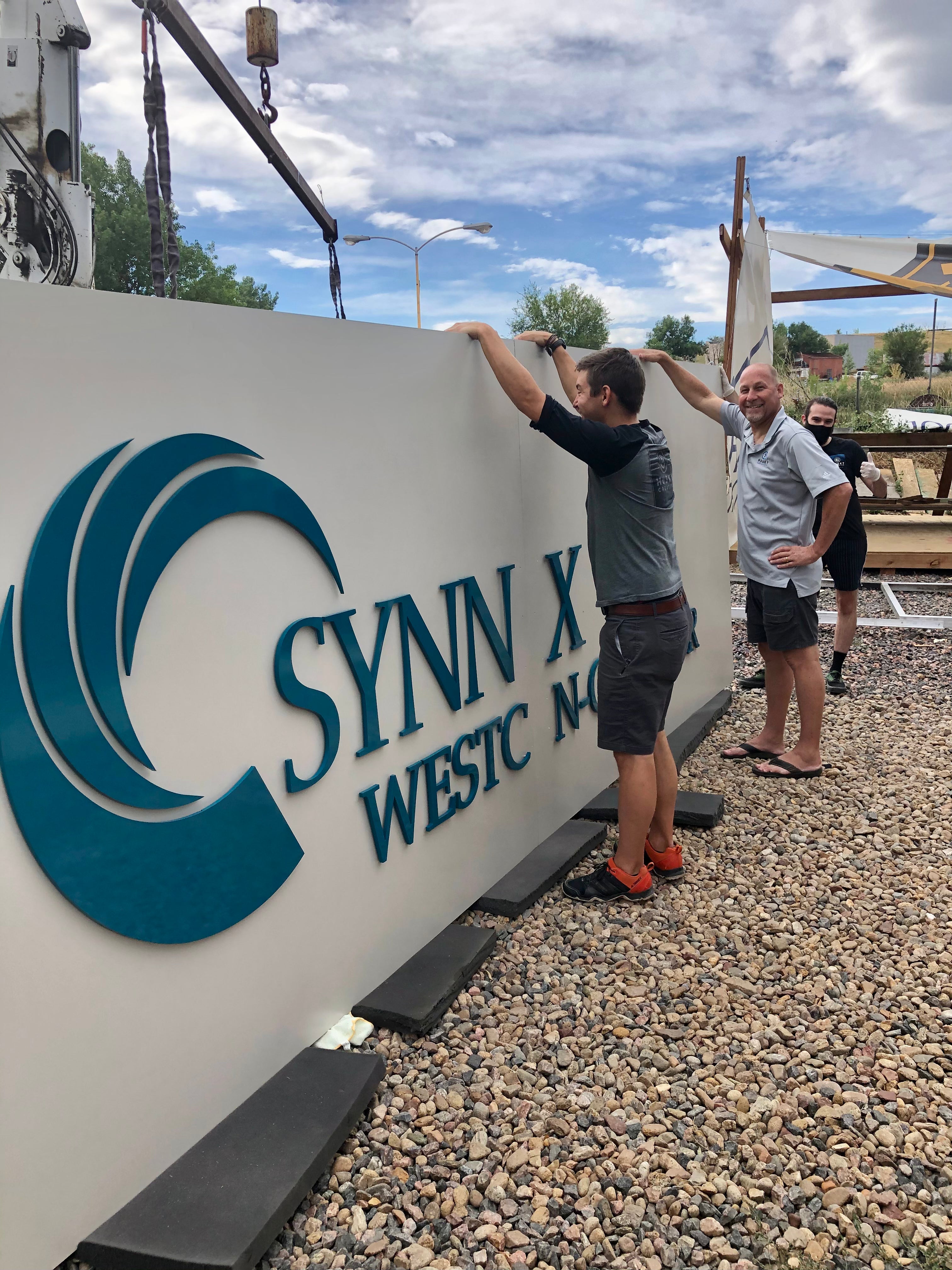 Exterior fabricated monument signage in install.