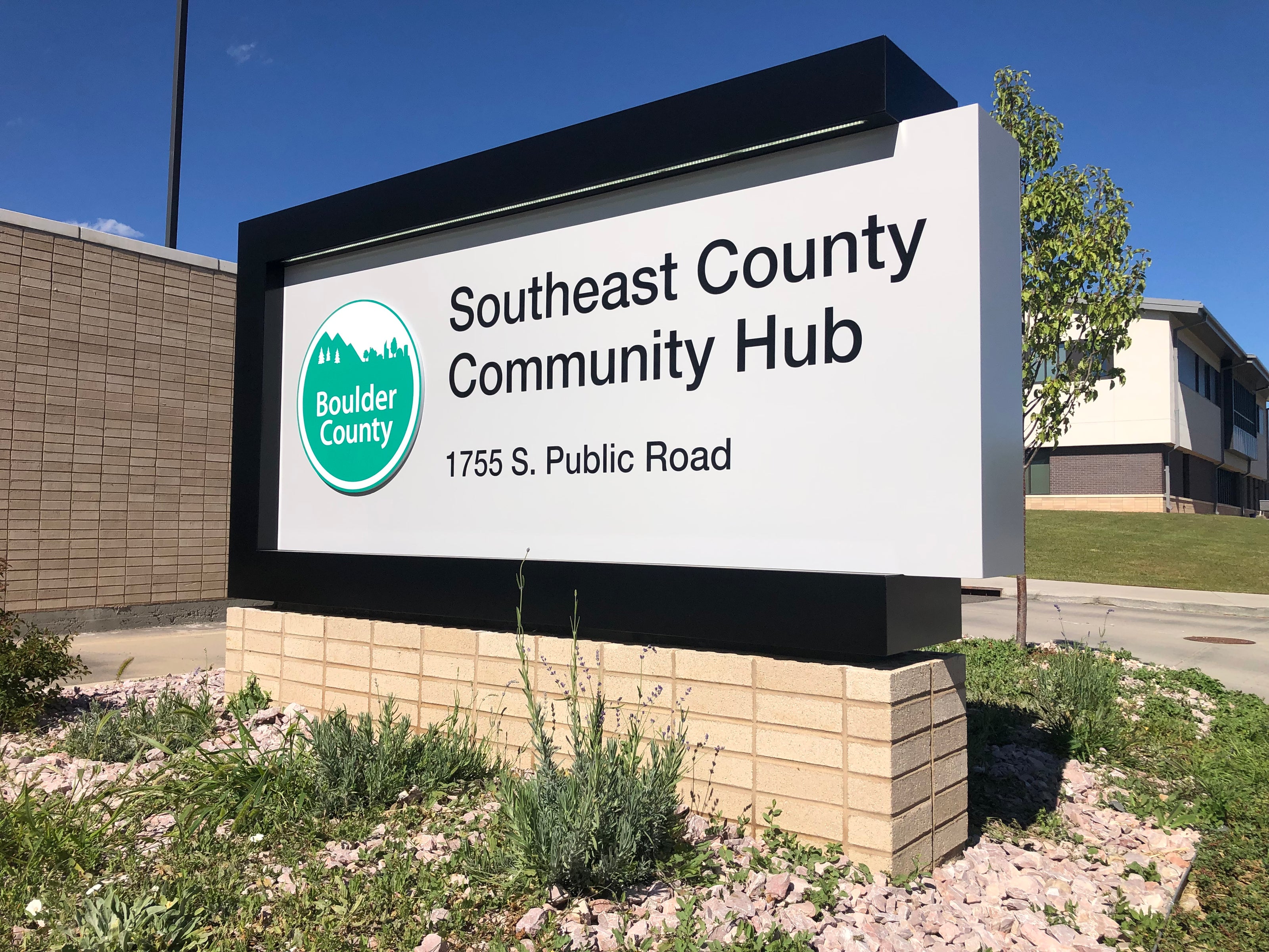 A clean and modern outdoor monument sign created for Boulder County’s Southeast County Community Hub in Boulder, Colorado. The sign has a white background with black text and features the green Boulder County logo.