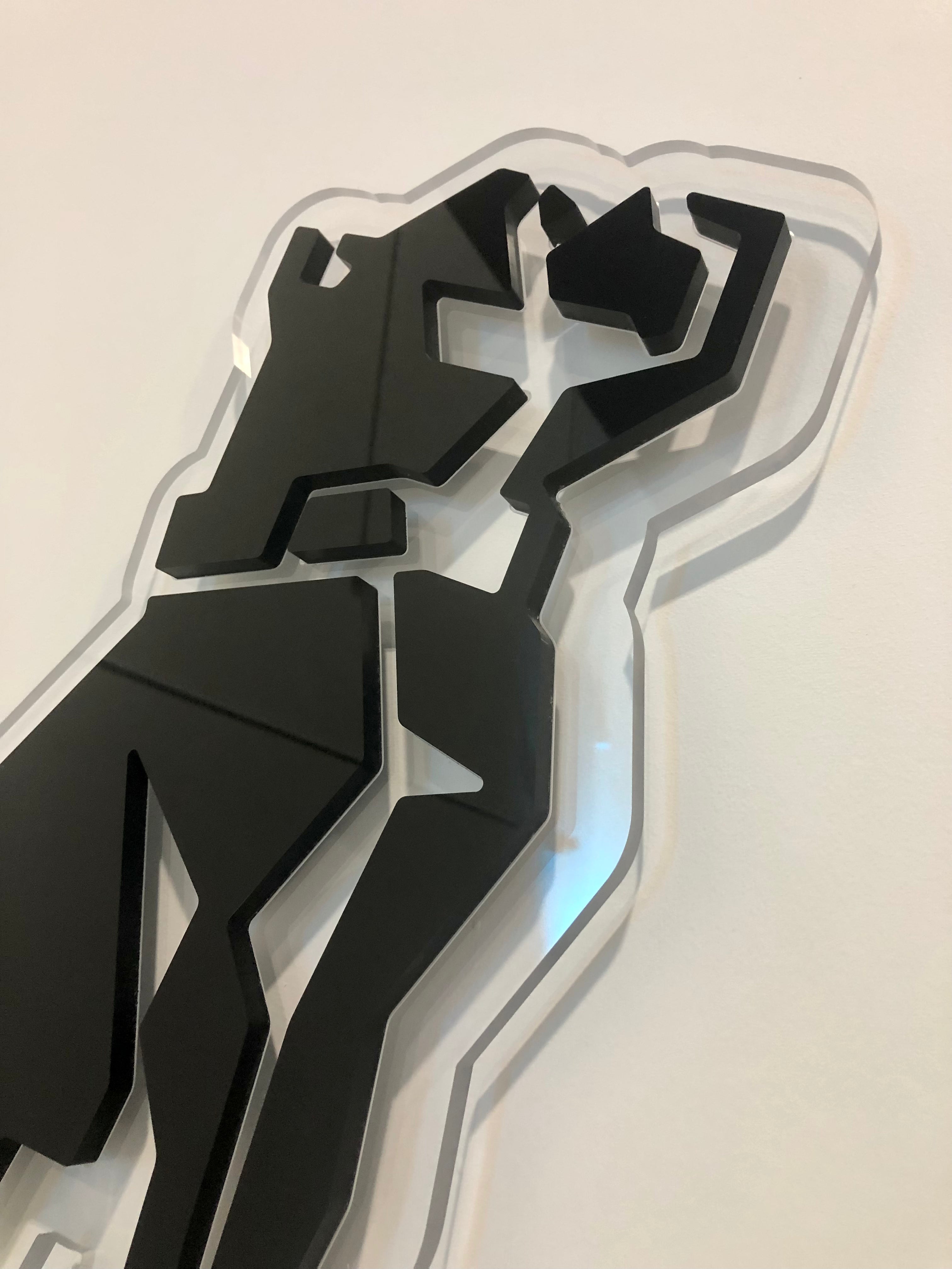 Close up of a black acrylic lobby sign for Mack Trucks in El Paso, Texas.