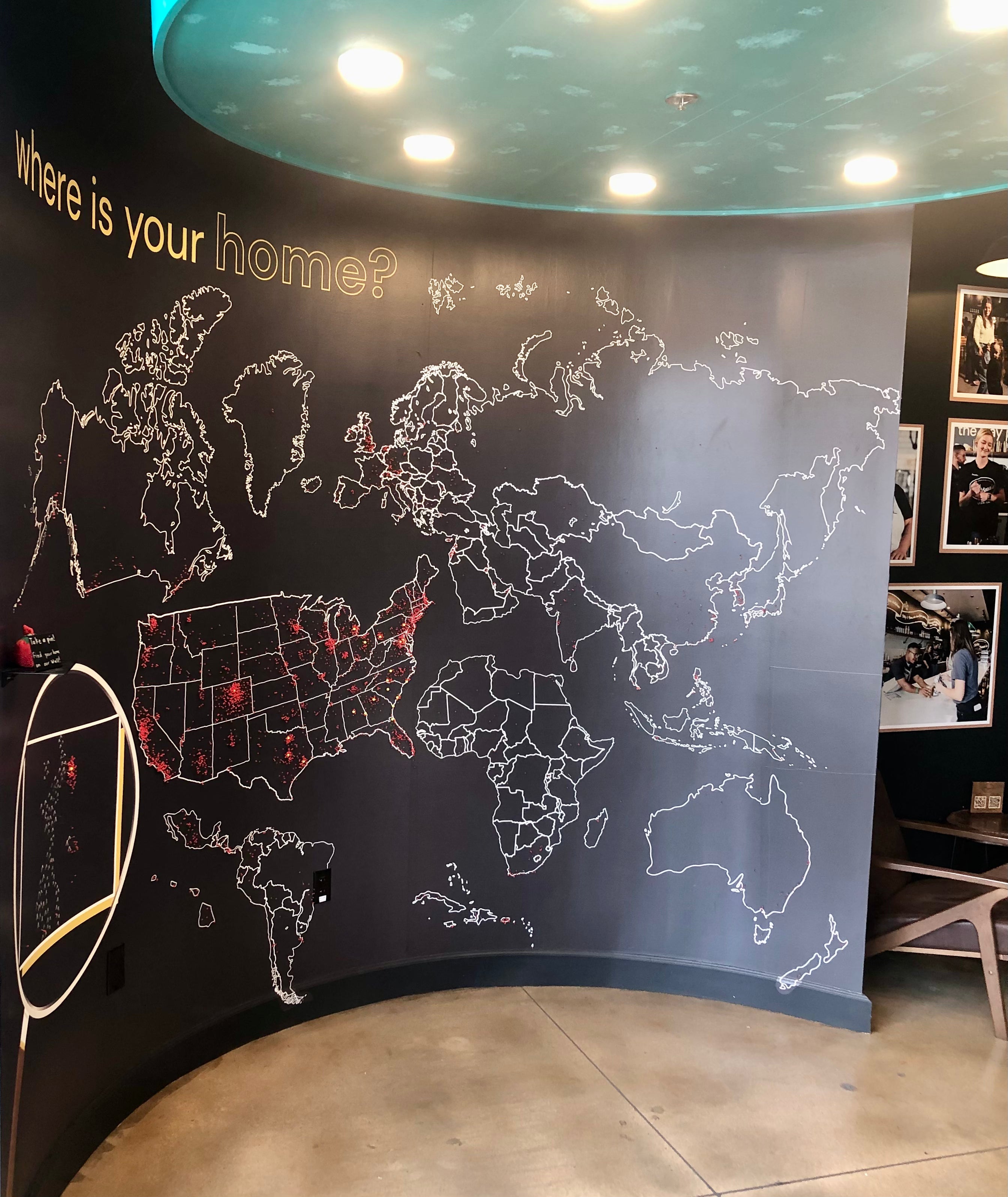 A fun wall wrap showcasing the entire globe, inviting customers to mark on the map where they are from.