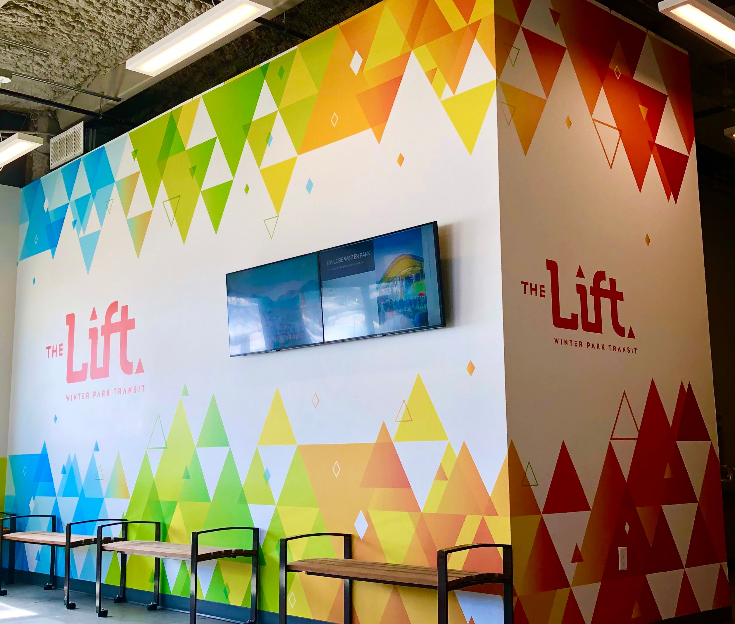 A powerful gradient of colors creating a unique and custom wall wrap for The Lift, Winter Park Transit in Winter Park, Colorado.