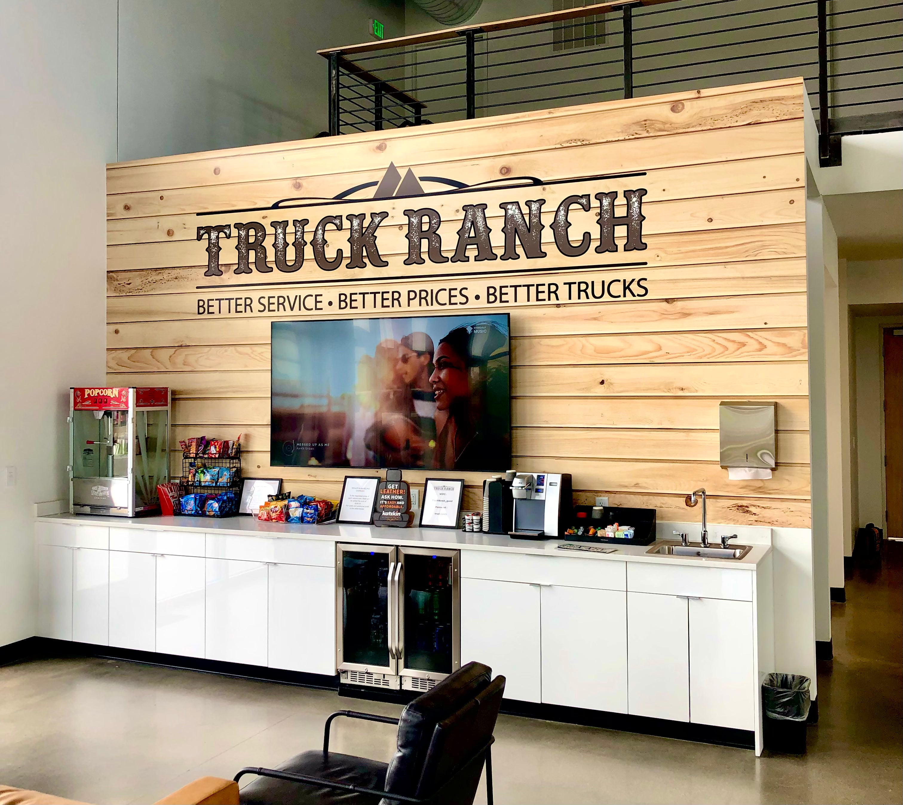 A wall wrap for the lobby of "Truck Ranch" in Frederick, Colorado. With their logo in bold lettering atop a fake wood design, it guarantees attention whenever someone steps into their lobby.