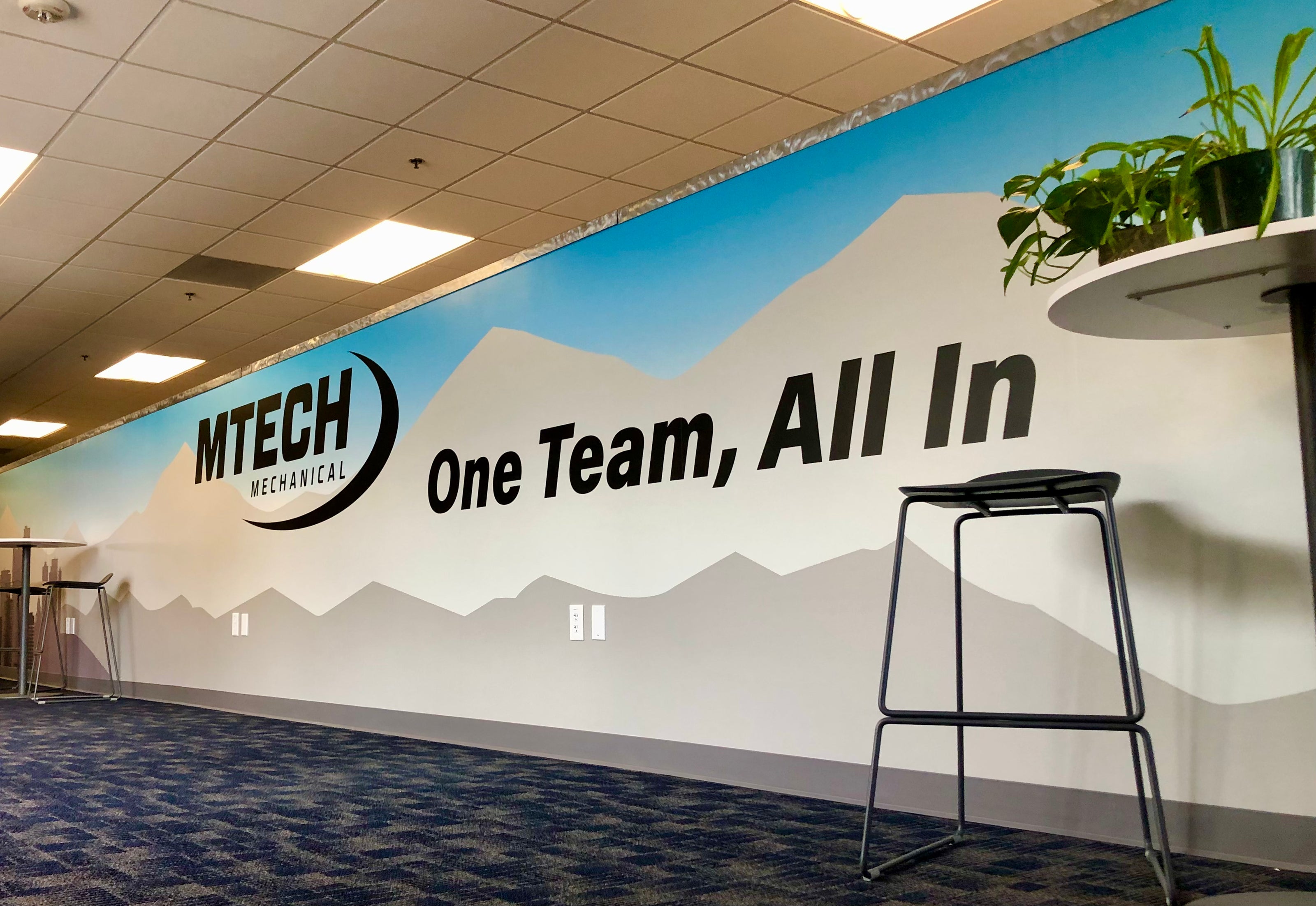 A wall wrap for MTech Mechanical's Westminster, Colorado location that builds team unity through their slogan of "One Team, All In."