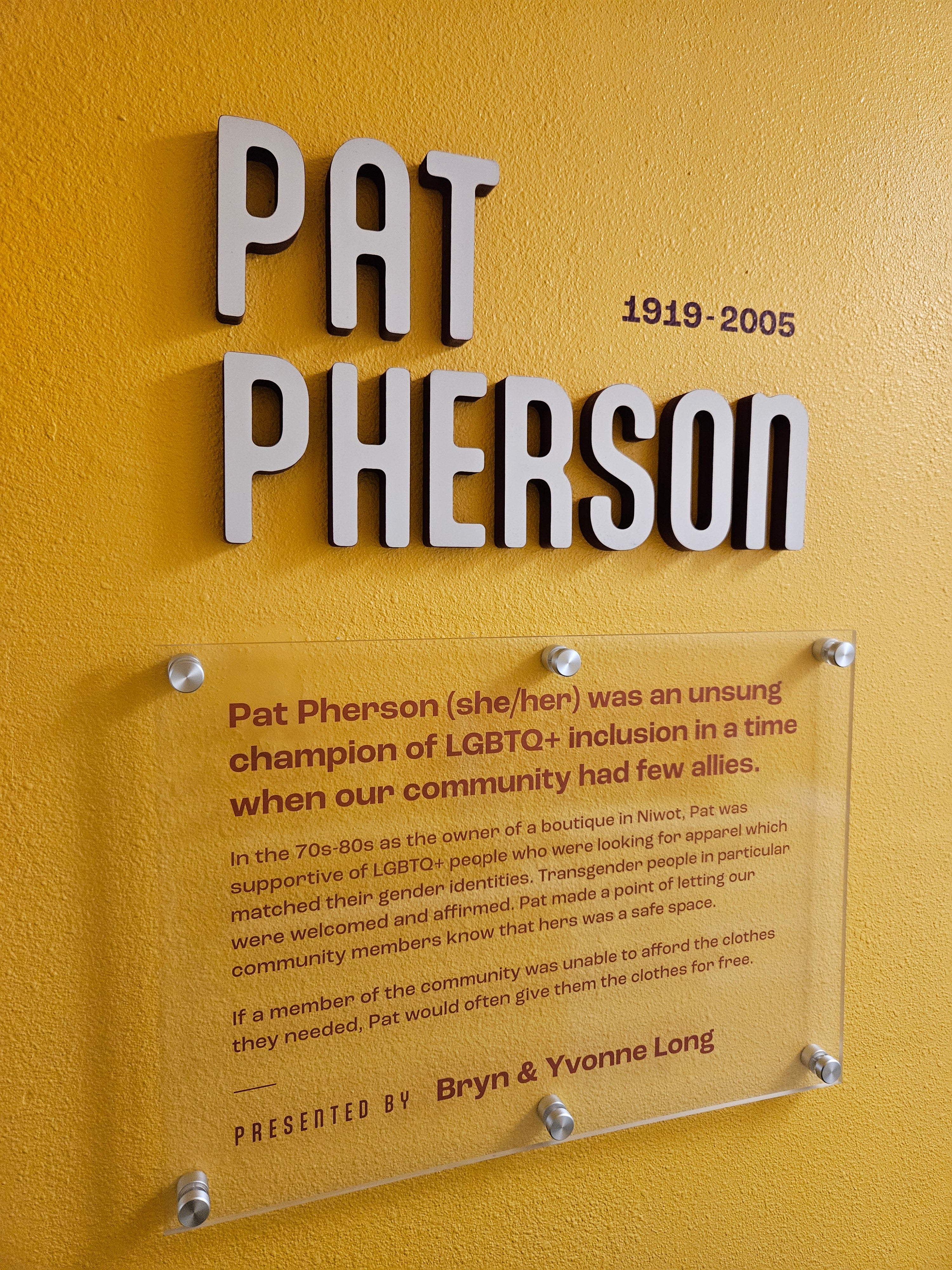 Wall lettering and an acrylic mounted sign accompanied with vinyl lettering for Pat Pherson at Rocky Mountain Equality in Boulder, Colorado.