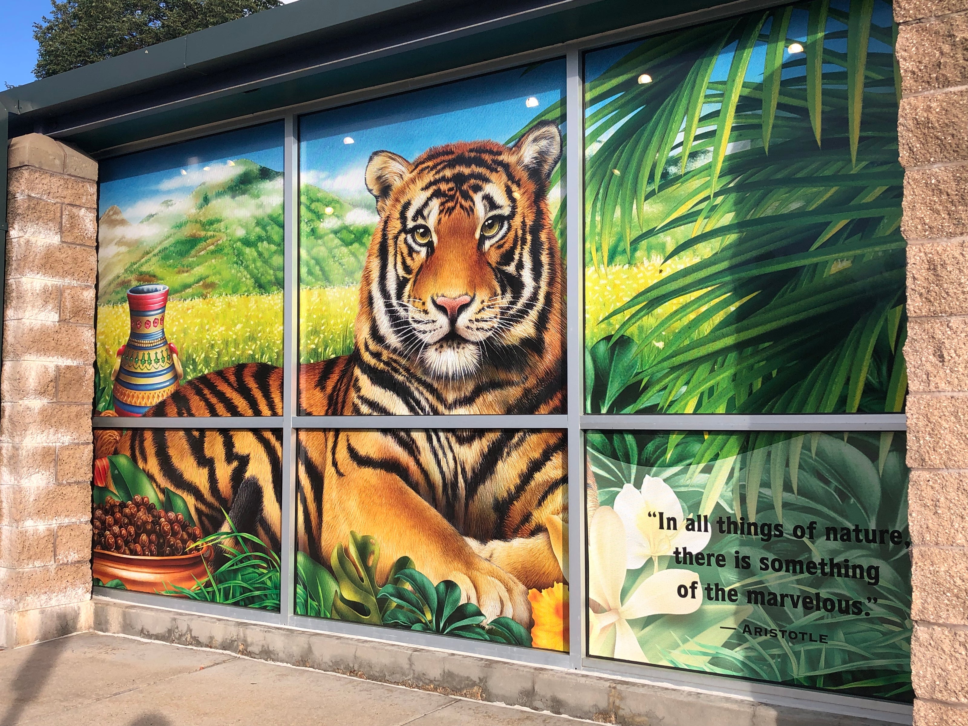 A vibrant exterior window wrap at Celestial Seasonings in Boulder, Colorado, featuring the brand’s iconic elements. The wrap covers the building’s windows, displaying colorful imagery and typography that reflect the company’s nature-inspired tea products.